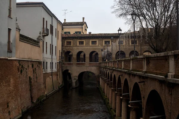 River In a town with an ancient porchway below street level on a cloudy day
