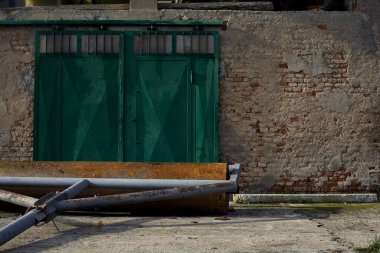 Facade of an abandoned country house with a wooden door on a cloudy day