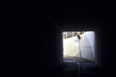 Passageway under a highway on a cloudy day