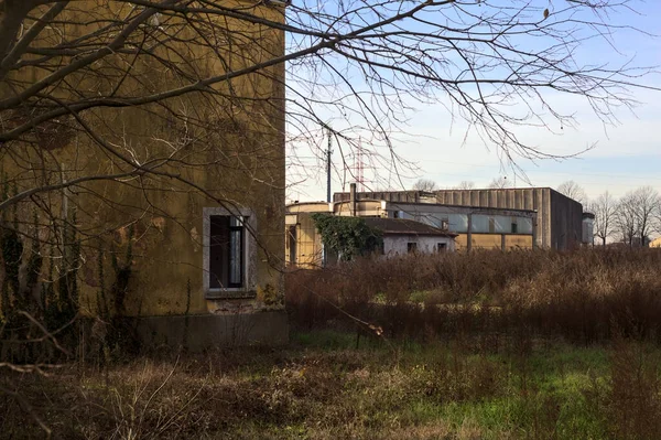 Abandoned industrial compound closed by a gate in the italian countryside