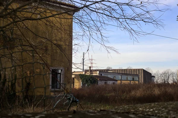 Abandoned industrial compound closed by a gate in the italian countryside