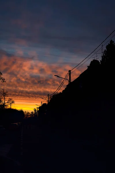 Sunset sky over a dark street of a rural town in winter