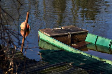 Moored boats in an inlet with reflections casted in the water