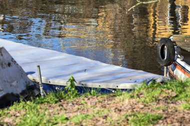 Moored boats in an inlet with reflections casted in the water
