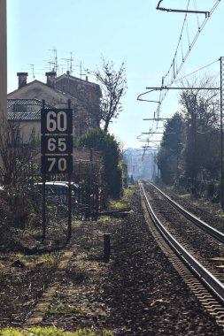 Railroad passing in a village in the italian countryside on a sunny day in winter