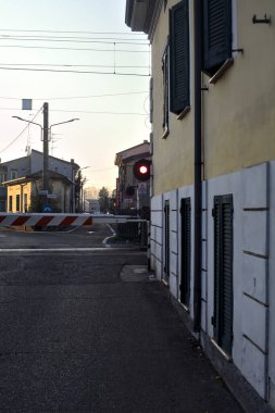 Railroad crossing in a rural town at sunset