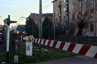 Train passing by in a rural town at sunset