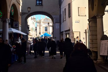 Avenue with people passing by in an italian town on a sunny day