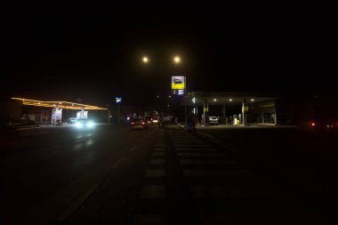 Gas stations on a country road at night
