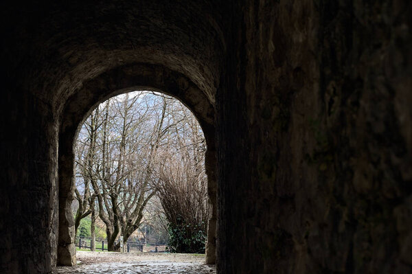 Dark and covered passage in the boundary wall of a castle