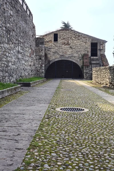 Paved passage to a building of a castle with the sky as background