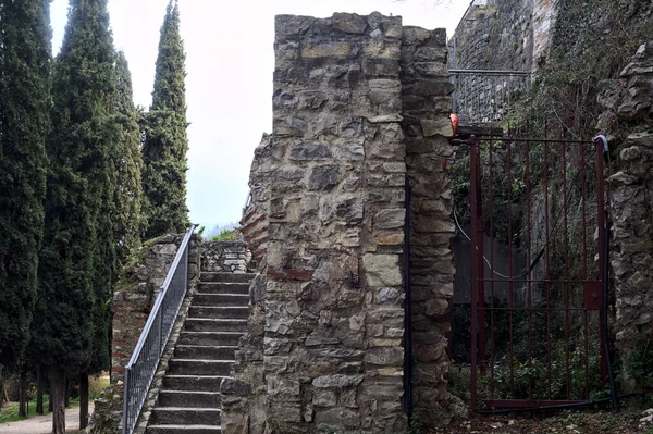 Stone staircase next to the boundary wall of a castle in a park