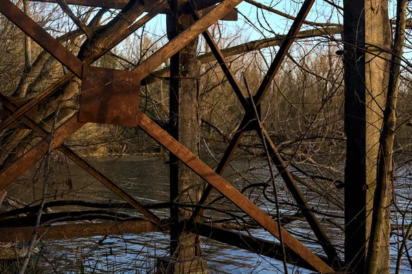 stock image Metallic structure by the lakeshore in a forest at sunset