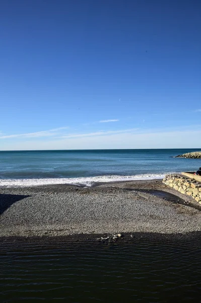 stock image Small empty beach between walls on a sunny day