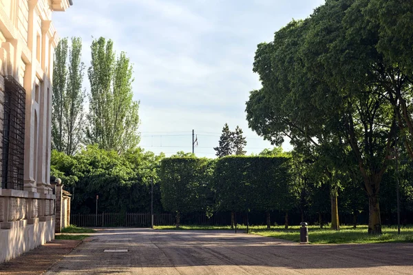 stock image Path in a park next to a palace in an italian town at sunset