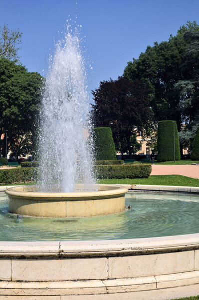 Fountain in the square of a park in an italian town on a sunny day
