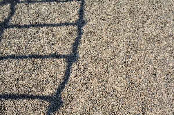 Shadow Ladder Cast Pebbles — стоковое фото