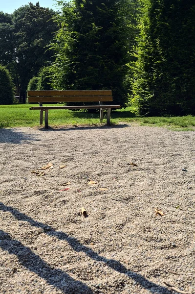 晴れた日に公園の遊び場の端に空のベンチ — ストック写真