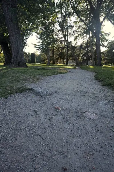 stock image Dirt path splitting in two in a park in an italian town at sunset