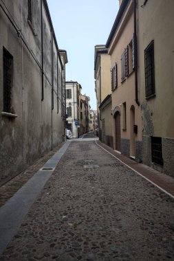 İtalya 'da bulutlu bir günde binalar arasında dar bir ara sokak.