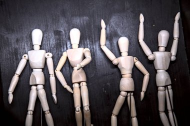 Tahta heykelcikler yere uzanmış, dinleniyormuş gibi poz veriyorlar.