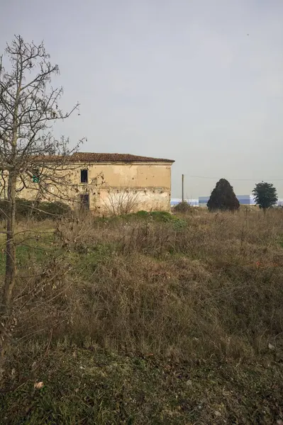 Abandoned country house next to a field