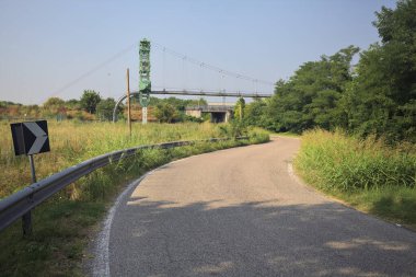 Bir köy yolunun üzerinden geçen boru hattı
