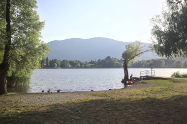 Gün batımında bir gölün kıyısında