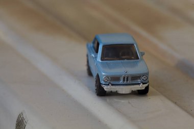 Mantova, İtalya - 27. Nisan 2025 - 1 / 64 Kibrit kutusu kopyası 1969 BMW 2002 beyaz metal bir plaka üzerine