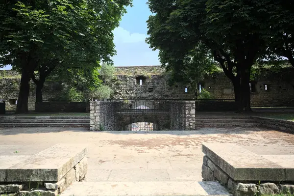 Güneşli bir günde, bir şatonun sınır duvarının yanındaki parkta küçük bir meydan inşa ettim.