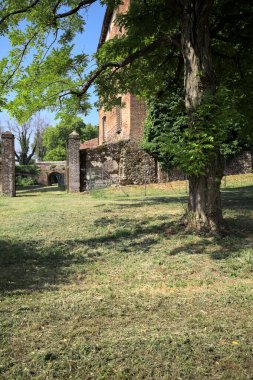 İtalya kırsalında güneşli bir günde bir bahçeden görülen bir şatonun köşesi.