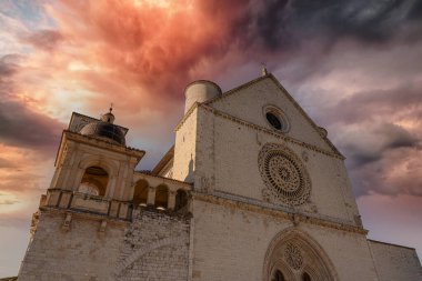 oblique view of the basilica of san francisco in the city of assisi at sunset