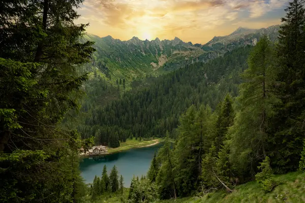 lake nambino refuge and trentino mountains at dawn