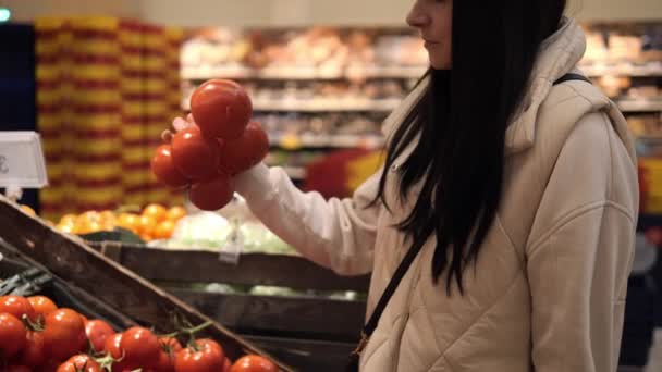 Young Woman Carefully Selects Tomatoes While Holding Branch Tomatoes Her — Stockvideo