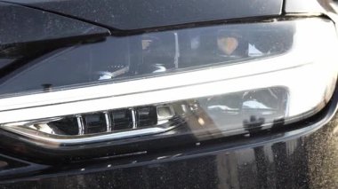 Araba farları kademeli olarak aydınlanıyor, gelişmiş LED ışıklandırma teknolojisi ve şık otomotiv tasarımı sergiliyor. Araba farları modern mühendisliği ön plana çıkarıyor..