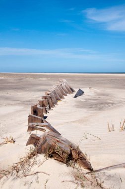 Photograph of an ancient shipwreck on the seafront