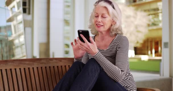 Portrait Lovely Senior Woman Sitting Bench Residential Building Texting Cellphone — Stock Video