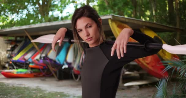 Young Woman Wetsuit Holding Kayak Paddle Shoulders Kayaks Outdoor Setting — Stock Video