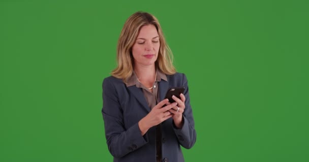 在绿色屏幕上用智能手机发短信的职业女性 在绿色屏幕上键入或合成 — 图库视频影像