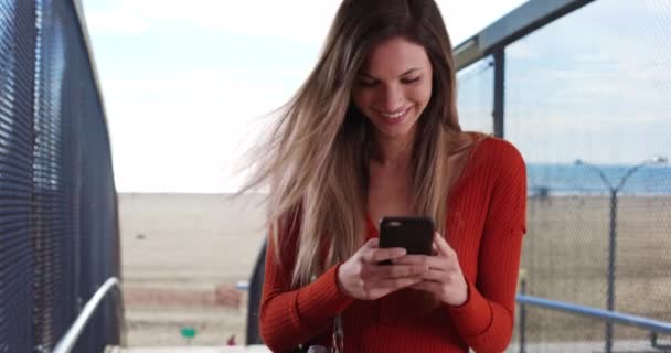 Millennial Woman Texting Smartphone Looking Happy While Beach Caucasian Girl — Stock Video