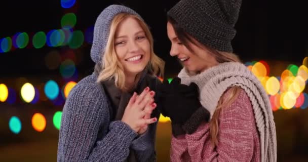 Twee Mooie Dames Winterkleding Warmen Zich Een Kleurrijke Bokeh Achtergrond — Stockvideo