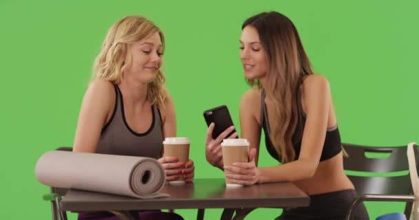 Cute Attractive Women Seated Table Yoga Mats While Looking Smartphone — Stock Video