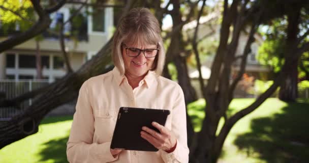 Happy Older Woman Playing Portable Tablet Computer Outdoors Public Park — Stock Video