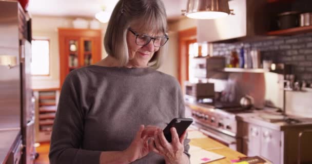 Güzel Olgun Bir Kadın Mutfakta Mesaj Göndermek Için Akıllı Telefon — Stok video