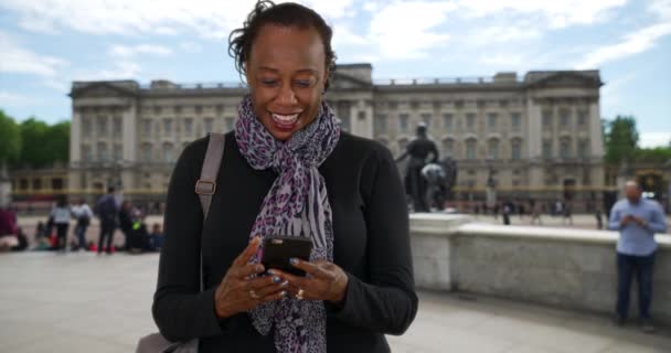 Portret Starszej Czarnej Kobiety Piszącej Smsy Smartfonie Niedaleko Pałacu Buckingham — Wideo stockowe