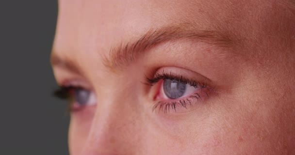 Close Caucasian Woman Blue Eyes Looking Camera Grey Background Beautiful — Stock Video