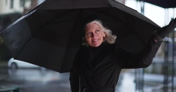 Portrait Elegant Senior Woman Standing Black Umbrella Dancing Rain Parking — Stock Video
