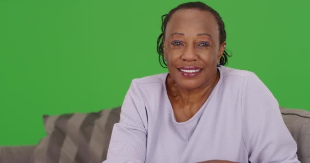 年配の黒人女性が喜んで緑の画面上のカメラを見ている 緑の画面でキーまたは構成されます — ストック動画
