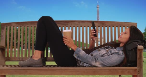 Caucasian Millennial Woman Jean Jacket Lying Park Bench Eiffel Tower — Stock Video