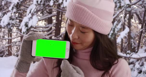 Szczęśliwa Azjatka Zimowej Odzieży Gospodarstwa Smartfon Zielonym Ekranem Śnieżnym Miejscu — Wideo stockowe
